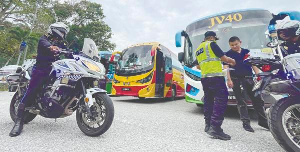 SAFETY INSPECTION ... Road Transport Department officers checking a bus driver’s documents during an integrated operation at the Gombak Enforcement Station. – ADIB RAWI YAHYA/THESUN