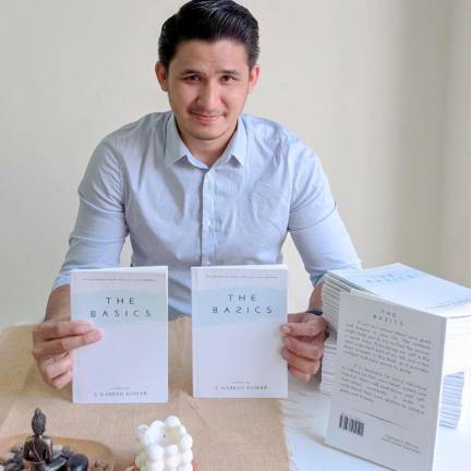 Naresh with his first book, The Basics. - Photo courtesy of Naresh Kumar Sukumaran