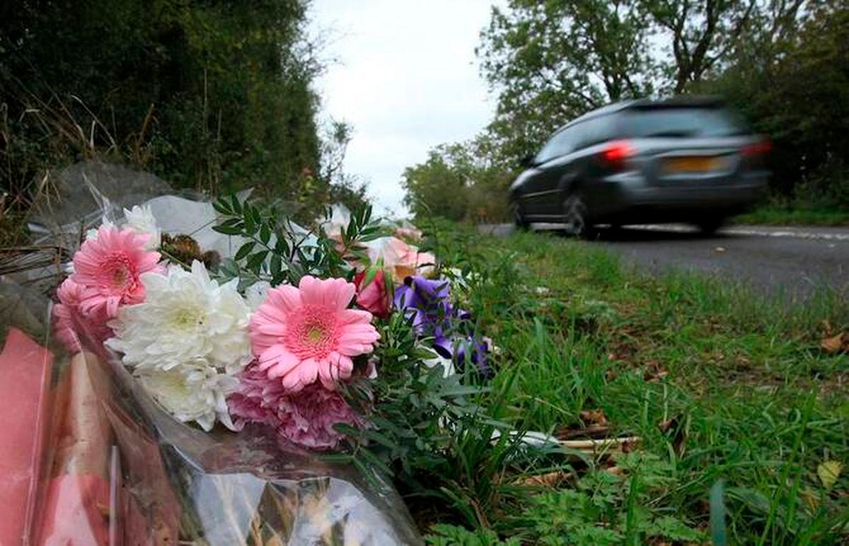 Above, floral tributes lay on the roadside near RAF Croughton in Northamptonshire, central England on Oct. 10, 2019, at the spot where teenager Harry Dunn was killed. (AFP file photo)