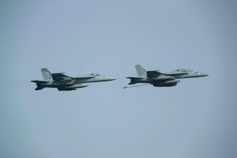 Two F/A-18 Super Hornets assigned to Carrier Air Wing 7 (CVW 7) demonstrate in-flight refueling during an Independence Day air power demonstration above the Nimitz-class aircraft carrier USS Abraham Lincoln (CVN 72), in Arabian Sea, July 4, 2019. AFPPIX