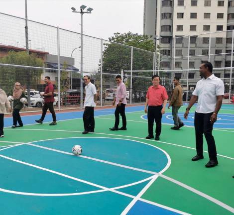 Chow (in red) getting a feel of the futsal court at the complex. – T.C. Khor/theSun