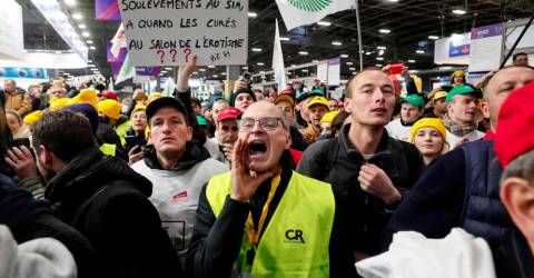 Angry French farmers storm into agriculture fair in Paris