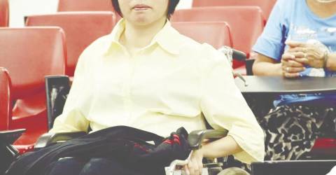 Wheelchair user facing uphill climb in job quest