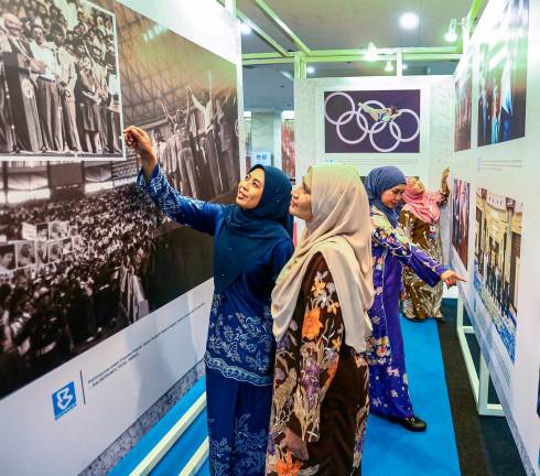 Media staff visiting a photography exhibition held in conjunction with the National Journalists’ Day 2025 celebration in Kuala Lumpur yesterday. – ADAM AMIR HAMZAH/THESUN