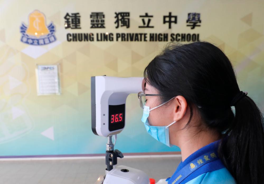 A staff at SMK Chung Ling (Independent) Loo Jee Ying conducting an inspection on body temperature equipment as preparation for the school resumption of Form 5 and Form 6. MASRY CHE ANI/THE SUN