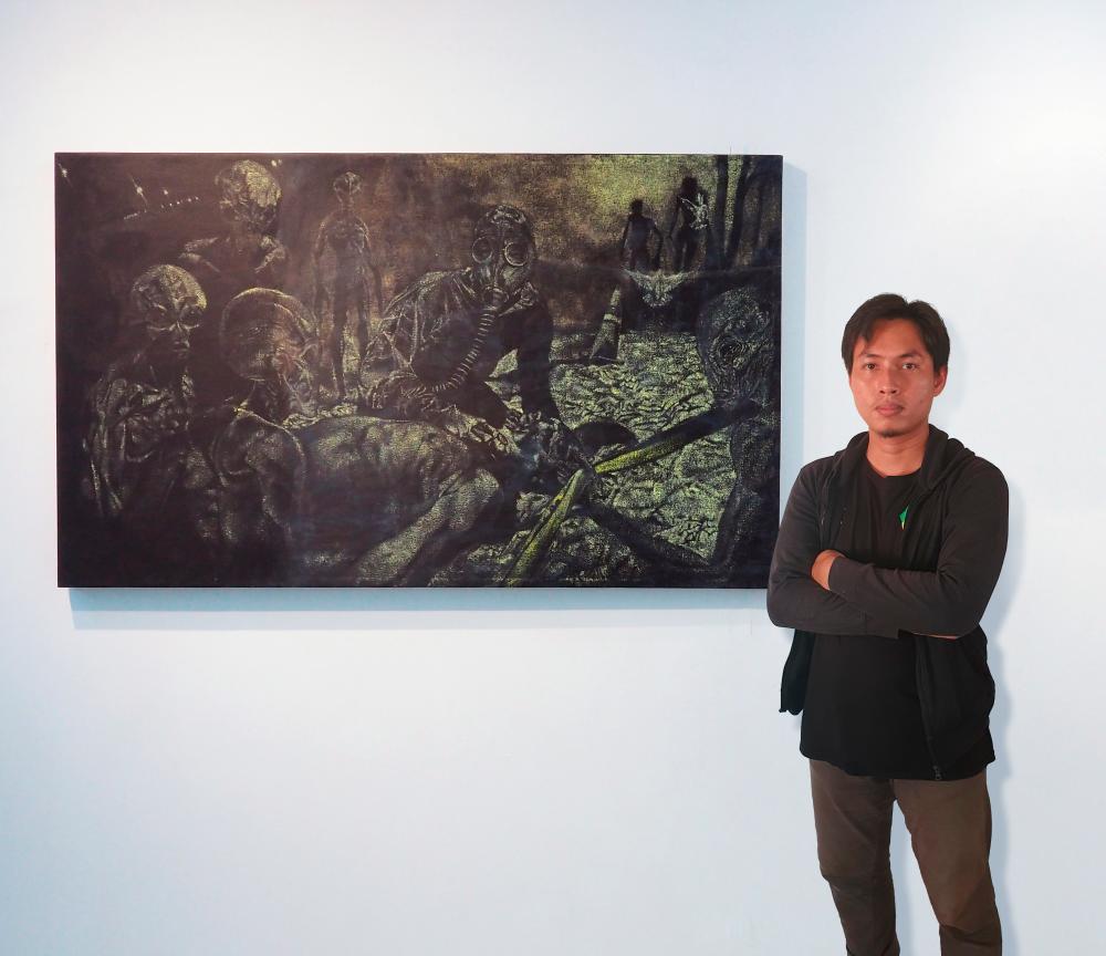 Faiz with his painting titled ‘Invasion’.