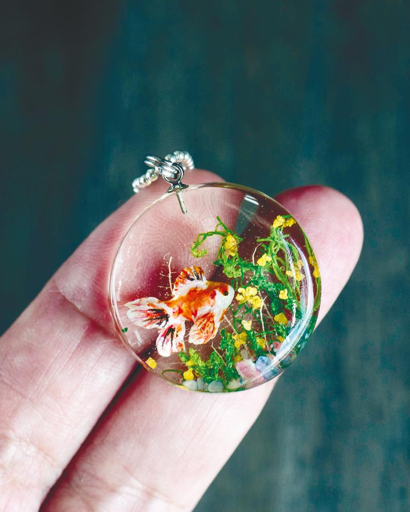 $!Polymer clay Goldfish set in resin with dried flowers and moss.