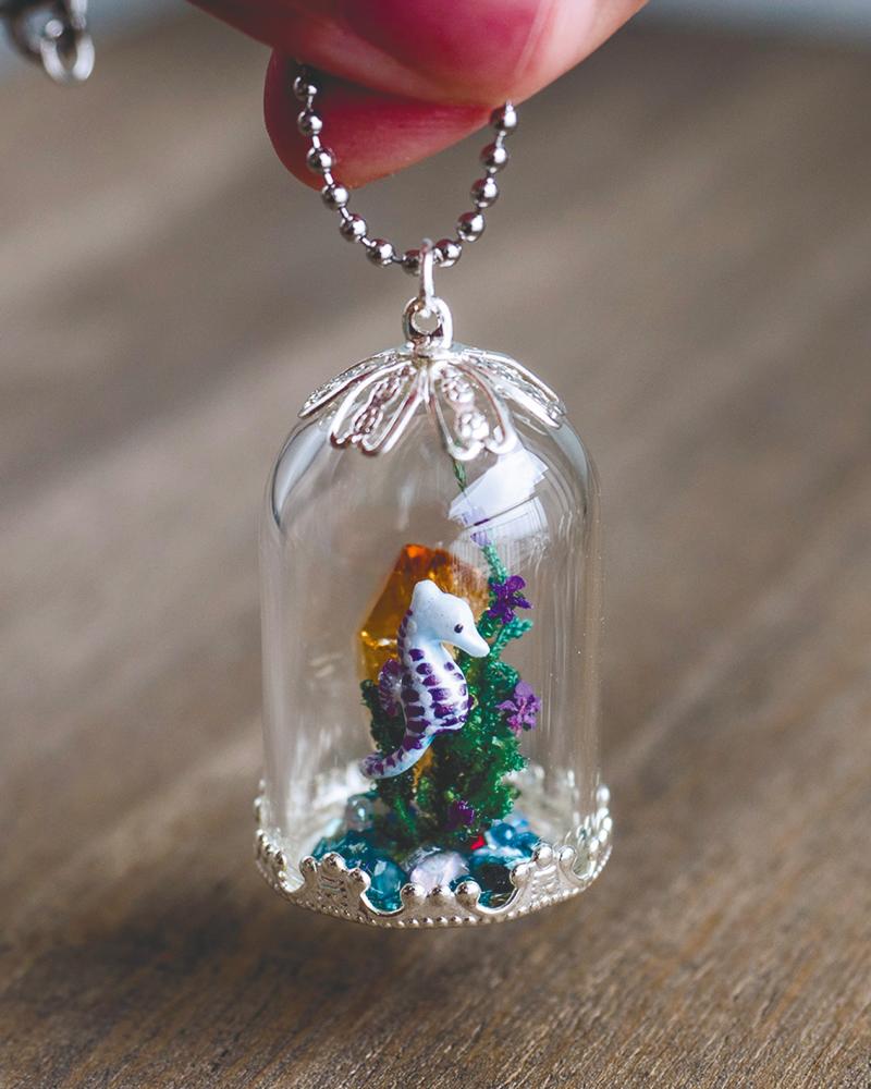 $!Seahorse inside a glass pendant.