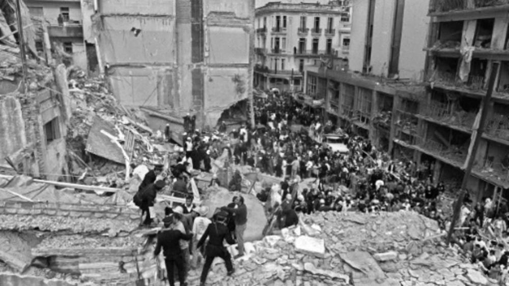 Firemen search for wounded people after a bomb exploded at the Argentine Israelite Mutual Association in Buenos Aires on July 18, 1994. — AFP