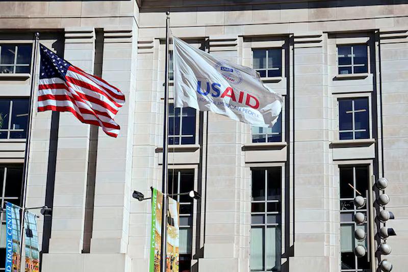 An American flag and USAID flag fly outside the USAID building in Washington, D.C. - REUTERSpix