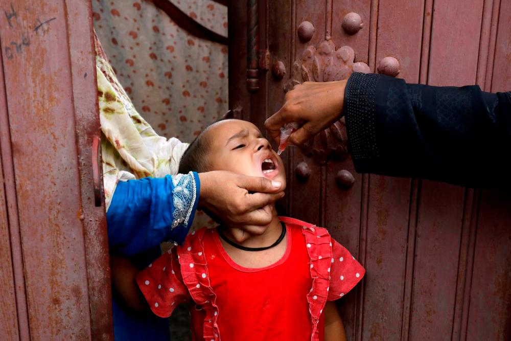 A girl receives polio vaccine drops, during an anti-polio campaign, in a low-income neighborhood as the spread of the coronavirus disease (Covid-19) continues, in Karachi, Pakistan July 20, 2020. REUTERSpix