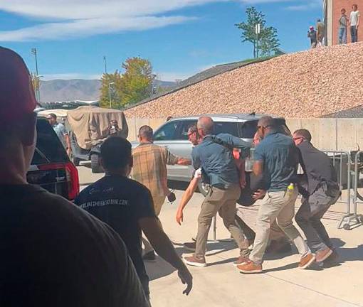This screen grab from a video by Jeremy King shows security personnel carrying right-wing youth activist and influencer Charlie Kirk after he was shot during a public event at Utah Valley University in Orem, Utah, on September 10, 2025. Kirk, a major ally of US President Donald Trump, was shot dead in an apparent assassination that sparked fears of more political violence in an increasingly febrile United States. Trump confirmed on social media that Kirk, 31, had died from his injuries. AFP PHOTO / Jeremy King
