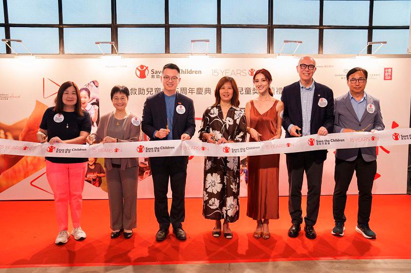 All the guests cut the ribbon for the Save the Children Hong Kong 15th Anniversary ceremony. From right to left: Tik Chi Yuen (Legco member), Donald Choi (Executive Director and CEO of the Chinachem Group), Grace Chan (Celebrity), Carol Szeto (CEO of Save the Children Hong Kong), Ho Kai Ming (Acting Secretary for Labour and Welfare), Linda Lam (Chairperson of the Equal Opportunities Commission), and Dr. Phyllis Chan (Honorary Clinical Associate Professor, Department of Psychiatry, HKU).