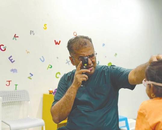 Sunder examining a patient’s eyes. Children should have an annual comprehensive eye checkup with a qualified optometrist or ophthalmologist.