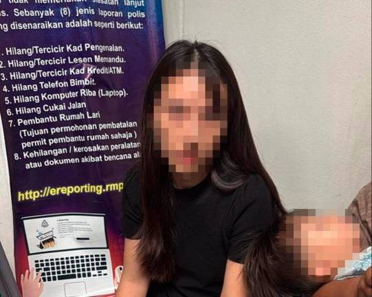 The female tourist after being detained by airport security personnel (AVSEC). - Pic courtesy of AKPS