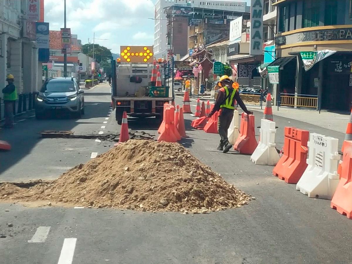 The sinkhole being repaired and tended to by IWK workers. - Pic courtesy of Indah Water Konsortium Sdn Bhd Facebook