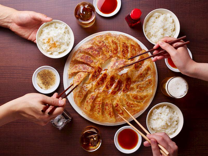 $!*Fried Gyoza with the perfect HANE paired with beer, sauce, and rice in a traditional Japanese meal.