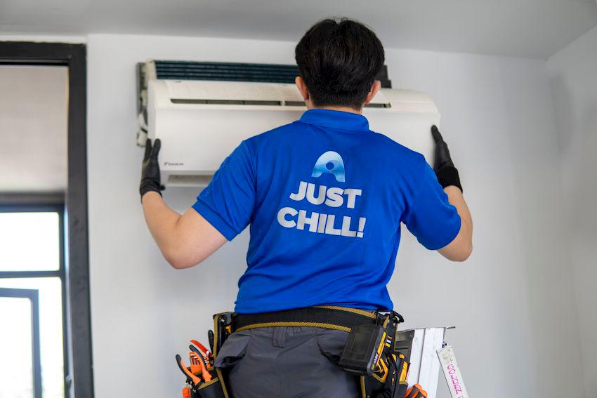 Airple technician servicing an air conditioner unit