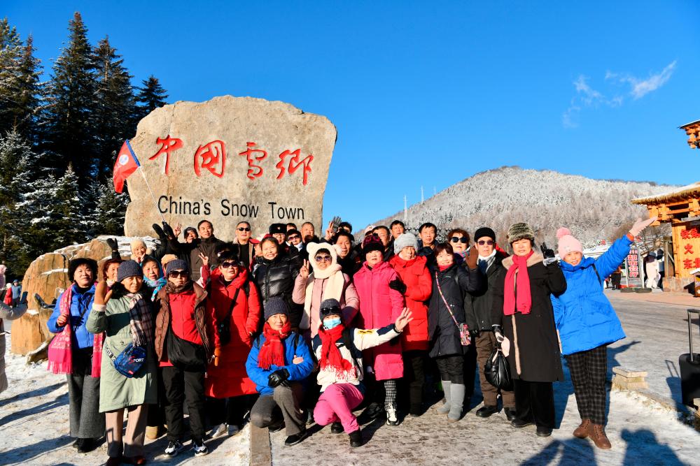 Tourists take a group photo in the “Snow Town”