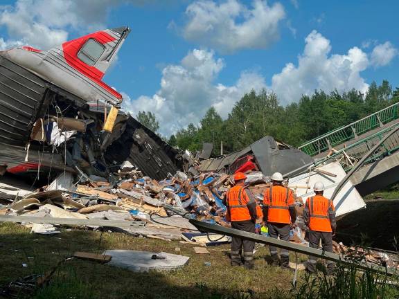 Specialists of emergency services work at the scene, after a road bridge collapsed onto railway tracks due to an explosion in the Bryansk region, Russia, June 1, 2025. - REUTERS/Stringer