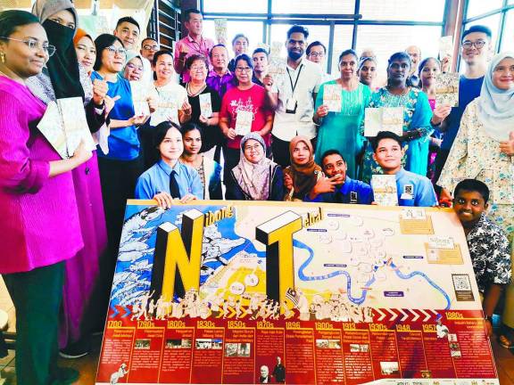 Chen (standing, fourth from left) with residents and members of the project team. – T.C. KHOR/THESUN