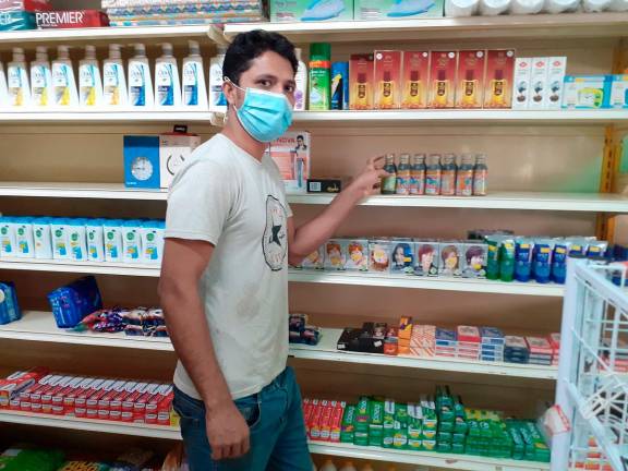 Bangladeshi worker Azad Hassan, resumes his job as a store helper after the near Plaza Pudu Area, Kuala Lumpur. - theSun pic