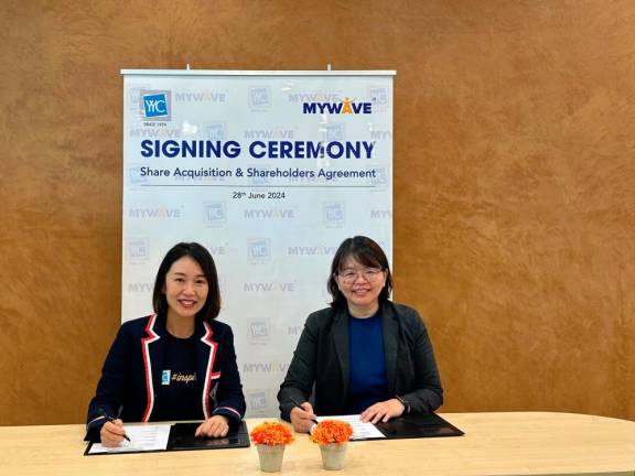 From left Yap Shin Siang, and Khoo Siew Ling during the signing ceremony of the Share Acquisition &amp; Shareholders Agreement.
