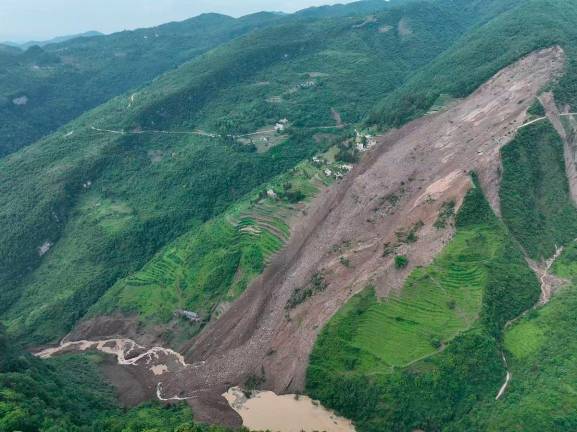 Damage from a landslide is seen in Dafang county, in China’s southwest Guizhou province on May 22, 2025. At least 19 people have been trapped by landslides in southwestern China’s Guizhou province on May 22, state media reported, with rescuers struggling to reach them in the mountainous terrain. - CNS / CNS / AFP