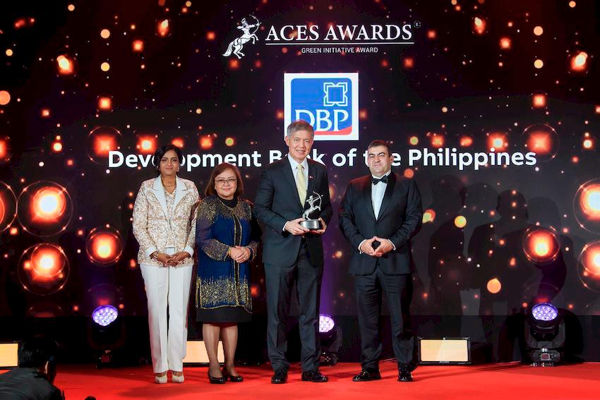 The Development Bank of the Philippines (DBP) shines at the ACES Awards 2024! Receiving the prestigious Green Initiative Award on Day 1, DBP was represented by Michael de Jesus, President and CEO (right center), and Carolyn Olfindo, SVP/Head of the Branch Banking Sector (left center). The award was presented by Dr. Shanggari Balakrishnan, President of the ACES Awards (far left), and Luis Bueno Nieto, Advisor to the ACES Council (far right). Adding to the celebration, Michael de Jesus was honoured on Day 2 with the Outstanding Leaders in Award, in recognition of his exemplary leadership that continues to drive DBP towards sustainable and impactful growth. DBP leading the way in green initiatives and inspiring leadership!