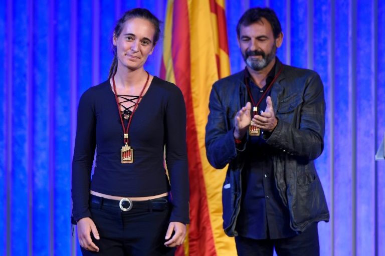 Migrant rescue ship captain Carola Rackete is given a medal from Catalonia’s regional parliament alongside Proactiva Open Arms founder Oscar Camps. — AFP