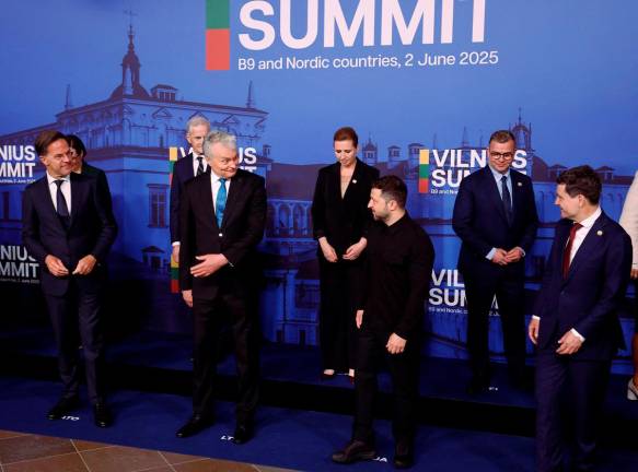 (First row, L-R) NATO Secretary Genaral Mark Rutte, Lithuania’s President Gitanas Nauseda, Ukrainian President Volodymyr Zelensky and Romania’s President Nicusor Dan prepare to pose for a family photo with other participants at the start of a summit with the leaders of NATO’s eastern and Nordic members (B9 and Nordic countries) on June 2, 2025 in Vilnius, Lithuania. - Petras Malukas / AFP
