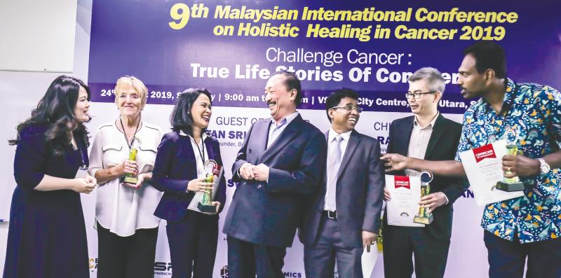 Tan (centre) with (form left) conference organising chairman Chan Quin Er, cancer survivors Eve Williamson and Claravil de Guzman, Cansurvive Centre Malaysia Berhad president Dr CD Siby, moderator Dr Tee Kian Keong and speaker M. Yogathevan. — Sunpix by Adib Rawi Yahya
