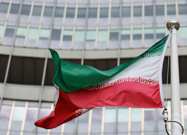 The Iranian flag flutters outside the IAEA headquarters in Vienna, Austria, June 9, 2025. - REUTERSpix