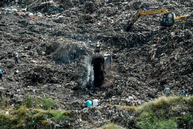 Rescuers searching the Pirana landfill in Ahmedabad for Neha Vasava, 12, who was buried while “rag picking” on the garbage dump. — AFP