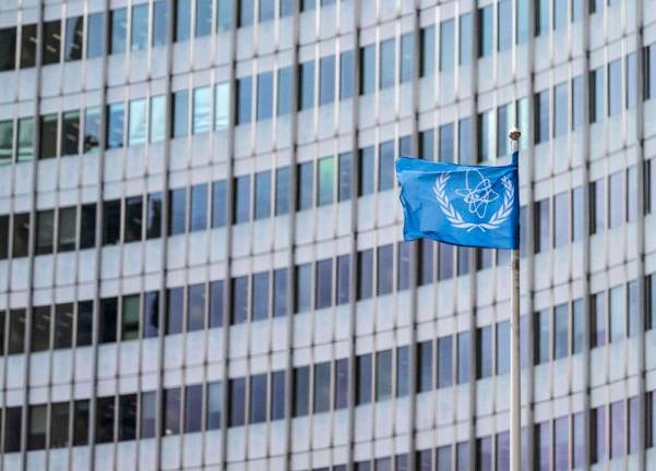 The IAEA flag flutters in the wind outside of the IAEA headquarters during the International Atomic Energy Agency IAEA's Board of Governors meeting at the agency's headquarters in Vienna, Austria, on November 20, 2024. Western countries on November 20, 2024 formally submitted a new resolution critical of Iran at the International Atomic Energy Agency ahead of its board meeting, diplomatic sources said. - Joe Klamar / AFPpix