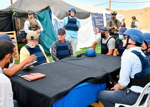 This handout photo from the US Embassy in Jerusalem shows US Ambassador to Israel Mike Huckabee (3L) and White House special envoy to the Middle East Steve Witkoff (C, seated) visiting a Gaza Humanitarian Foundation (GHF) food and aid distribution site inside the Gaza Strip on August 1 - AFP PHOTO / US EMBASSY IN JERUSALEM / DAVID AZAGURY