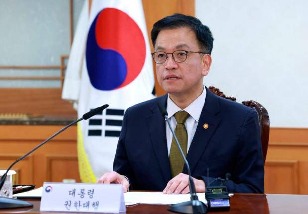 South Korea's Finance Minister and new acting president Choi Sang-mok speaks as he presides over a meeting of the National Security Council at the Government Complex in Seoul on December 27, 2024, after Prime Minister Han Duck-soo's impeachment motion was passed by the National Assembly. South Korea's new acting president, finance minister Choi Sang-mok, promised on December 27, to overcome the political turmoil that has gripped the country since the short-lived imposition of martial law early this month. - YONHAP / AFP