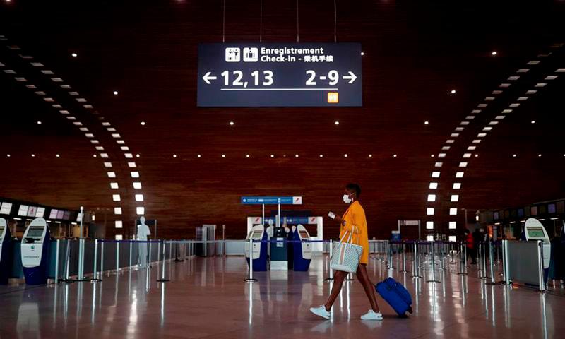 In this file photo, a woman makes her way in the departures area of the Terminal 2E at Charles-de-Gaulle airport amid the Covid-19 outbreak in Roissy, near Paris, France. - REUTERSPIX