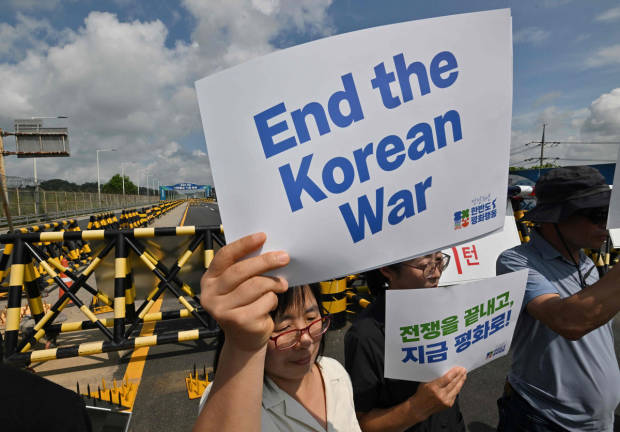 Anti-war activists hold a rally to mark the 70th anniversary of the signing of the Korean War Armistice Agreement, near a military check point on the Tongil bridge, the road leading to the truce village of Panmunjom, in the border city of Paju on July 27, 2023. - AFPpix