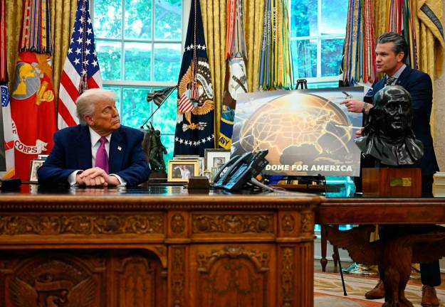 US President Donald Trump listens to US Secretary of Defense Pete Hegseth speaks about the Golden Dome missile defense shield, in the Oval Office of the White House on May 20, 2025, in Washington, DC. - Jim WATSON / AFP