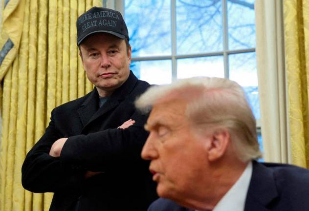 Elon Musk listens to U.S. President Donald Trump speak in the Oval Office of the White House in Washington, D.C., U.S., February 11, 2025. - REUTERS/Kevin Lamarque/File Photo