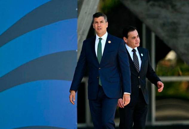 Paraguay’s President Santiago Pena (L) is pictured before the group photo after the first session of the G20 Leaders’ Meeting in Rio de Janeiro, Brazil, on November 18, 2024.