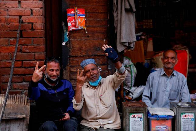 Kashmiri men react after the ceasefire announcement between India and Pakistan, in Srinagar May 10, 2025. - REUTERS/Sharafat Ali