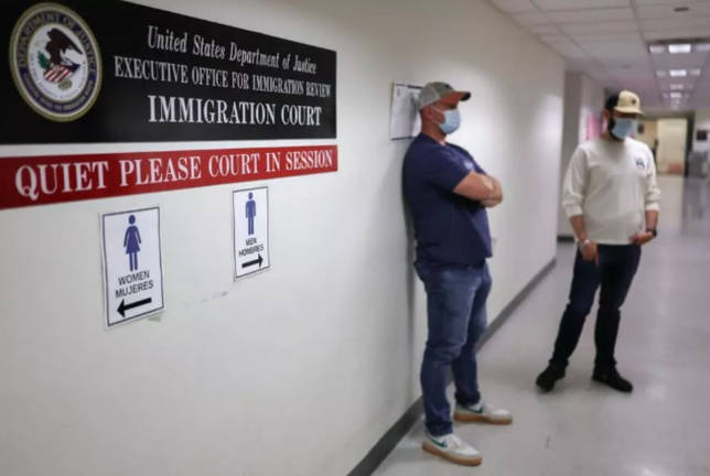 Plainclothes federal agents with US Immigration and Customs Enforcement wait in a hallway outside of an immigration courtroom in New York City. - AFPpix