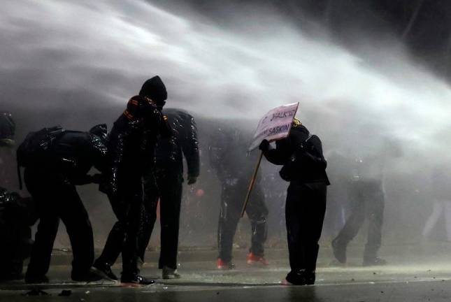 Turkish anti-riot police use water canon as they clash with Middle East Technical University (ODTU) students protesting against the arrest of Istanbul’s mayor, in Ankara on March 20, 2025. Turkish police detained Istanbul’s powerful Mayor Ekrem Imamoglu on March 19, in connection with two investigations into graft and “supporting terror,“ a move that the main opposition party slammed as a politically-motivated “coup”. - Adem ALTAN / AFP
