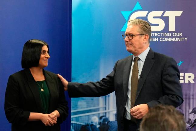 Britain’s Home Secretary Shabana Mahmood (L) and Britain’s Prime Minister Keir Starmer react as they speak to members of the Jewish community at the Community Security Trust (CST) in north west London on October 16, 2025, where they discussed the Government’s response to the attack at the Heaton Park synagogue in Manchester.- AFP