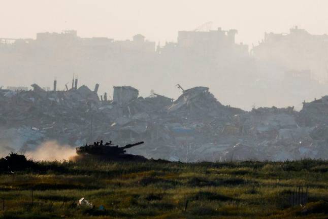 A tank manoeuvres inside Gaza, as seen from Israel’s border with Gaza, Israel March 19, 2025. REUTERSpix