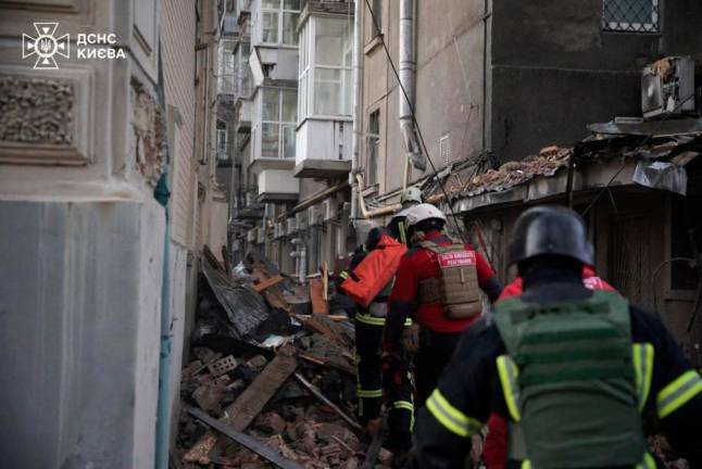 This handout photograph taken and released by the State Emergency Service of Ukraine on January 1, 2025, shows rescuers working at the site of a Russian drone attack on a residential building in Kyiv, amid the Russian invasion of Ukraine. AFP PHOTO / State Emergency Service of Ukraine