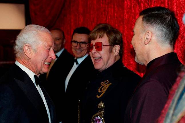 Britain’s King Charles meets Elton John and David Furnish as he arrives for the Royal Variety Performance at the Royal Albert Hall, in London, Britain, November 22, 2024. - REUTERS/Toby Melville/Pool/File Photo