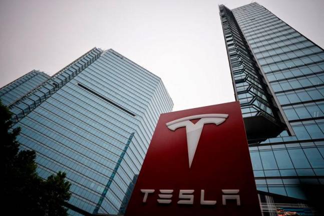 A Tesla logo is seen outside a showroom of the carmaker in Beijing, China.REUTERSpix